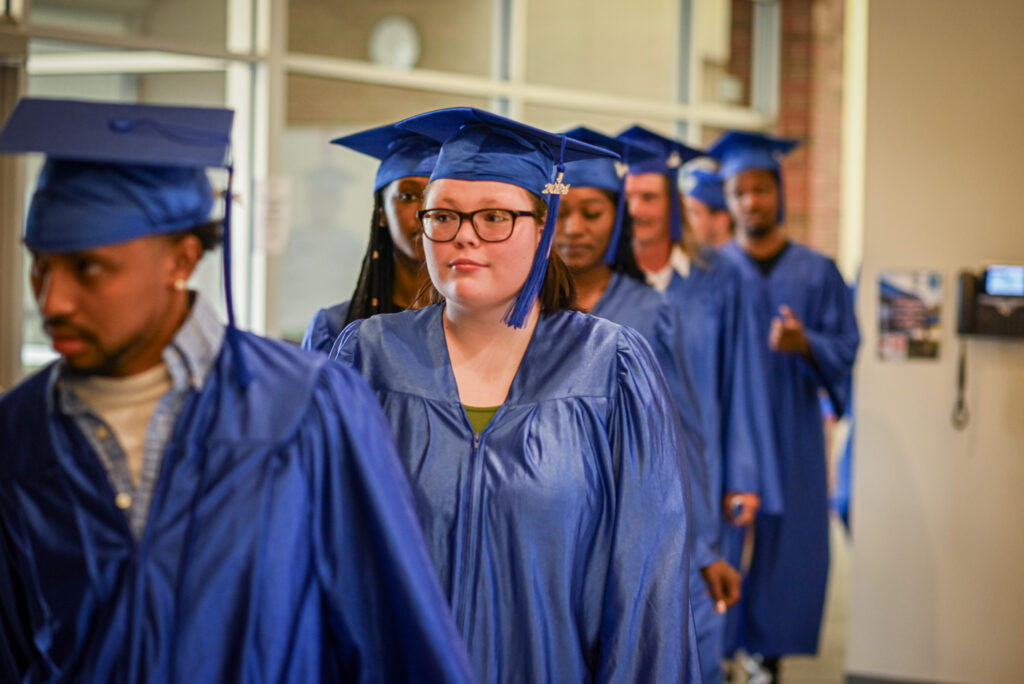 A line of students waits to enter the auditorium