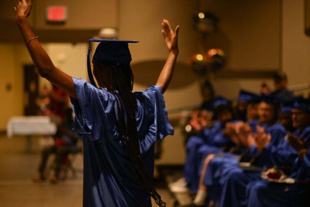 A student celebrates the completion of their course work